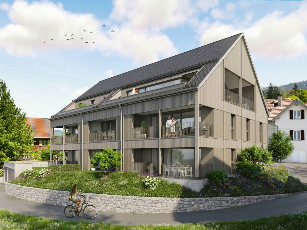 Die Visualisierung stellt die beiden geplanten Wohngebäude mit lasierten Holzfassaden, Satteldächern und großen Terrassen dar. Privatgärten, Wege und Baumpflanzungen gliedern die Hanglage. Visualisierung der Südwestansicht