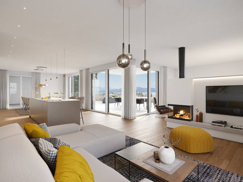 Der helle Wohnbereich verbindet ein Sofa mit dezenten Farbakzenten, einen dreiseitigen Kamin und die angrenzende Küche. Raumhohe Verglasungen führen auf die möblierte Terrasse und geben den Blick auf die umliegenden Berge frei. Riedergasse, Bregenz-Innenraum-Whg 26_04