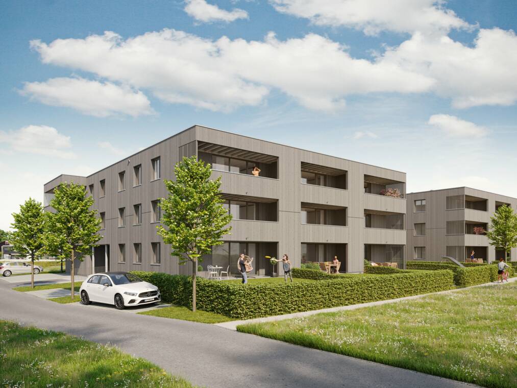 Aus südwestlicher Perspektive vermittelt das Rendering die dreigeschossige Bauform sowie die Verbindung der Wohnungen mit Terrassen und privaten Gartenflächen. Holzbau am Weidenweg aus Südwest